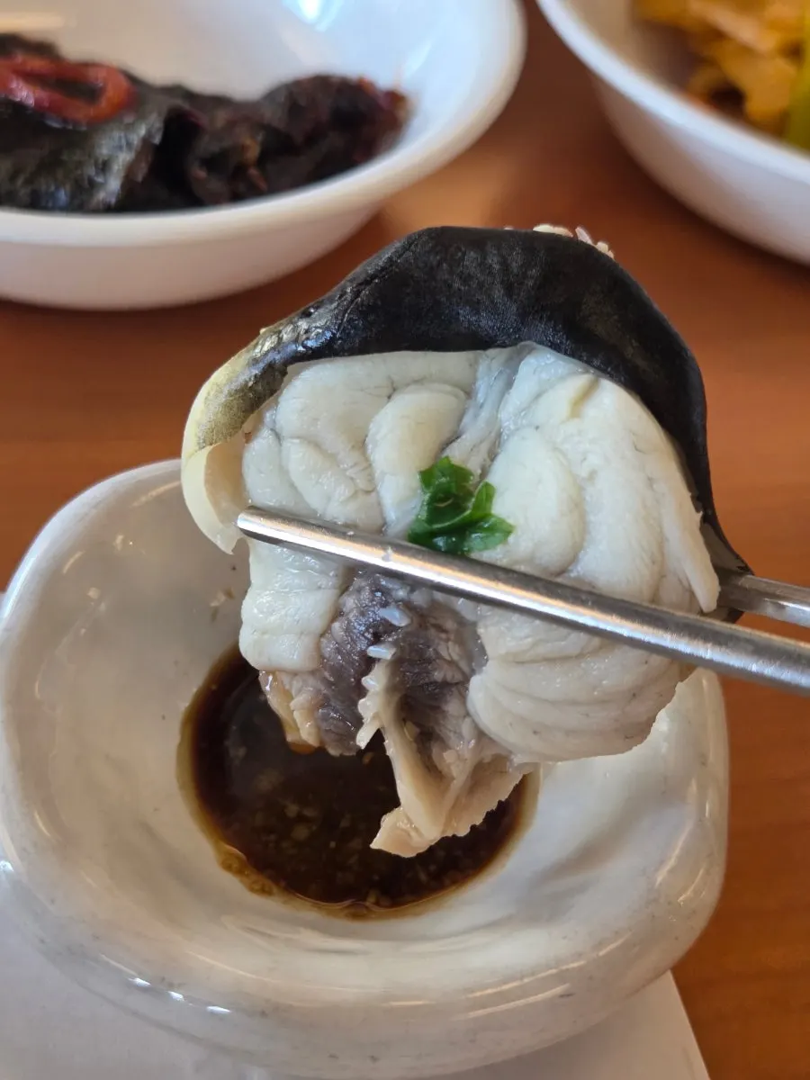 Bowl filled with clear milbok jiri broth