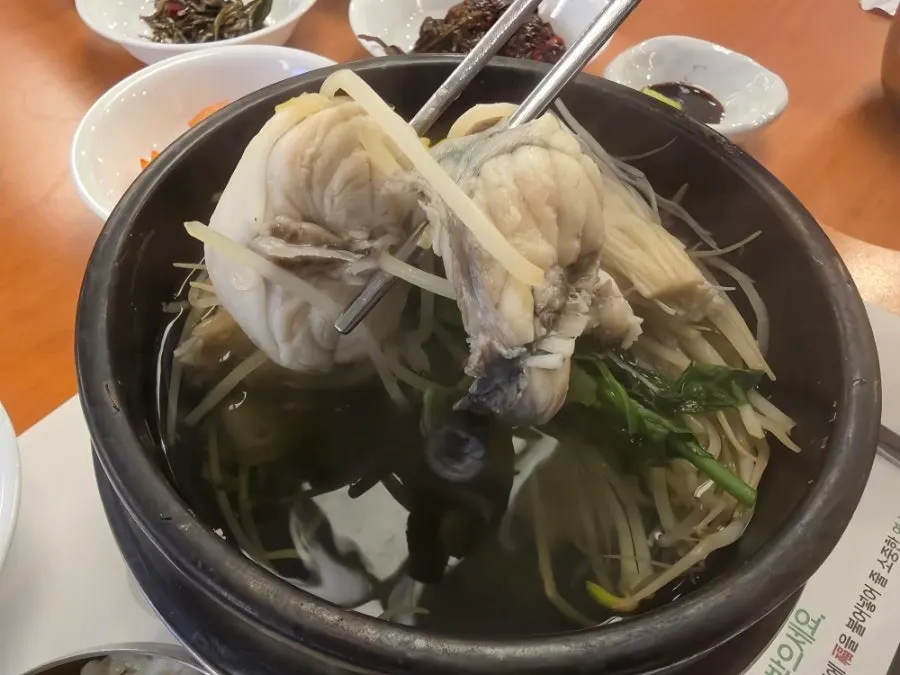 A spoonful of pufferfish meat with clear broth