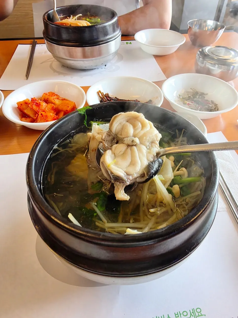Close-up of the milky-white milbok jiri broth