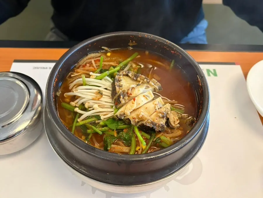 Spicy special pufferfish soup with abalone in an earthenware pot