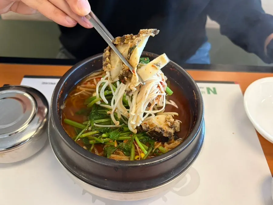 A bowl of pufferfish soup showing meat and skin