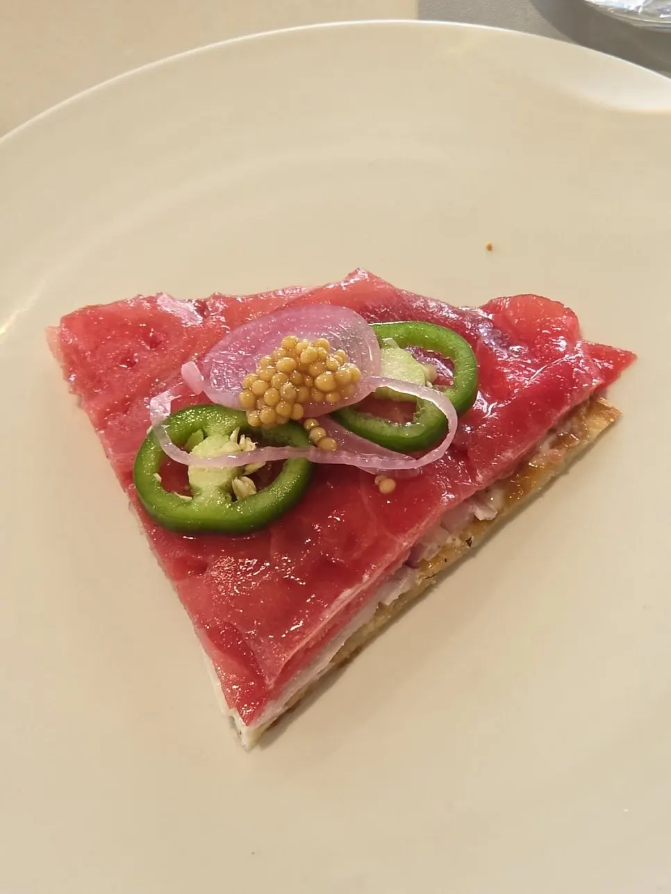 Cold pizza with raw tuna on a tortilla