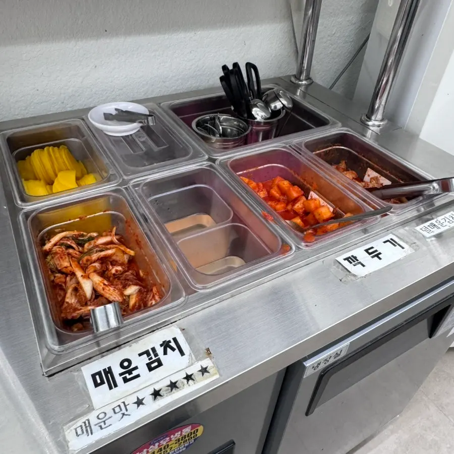 Side dish corner at the Cheongdam Dak Kalguksu self-serve bar