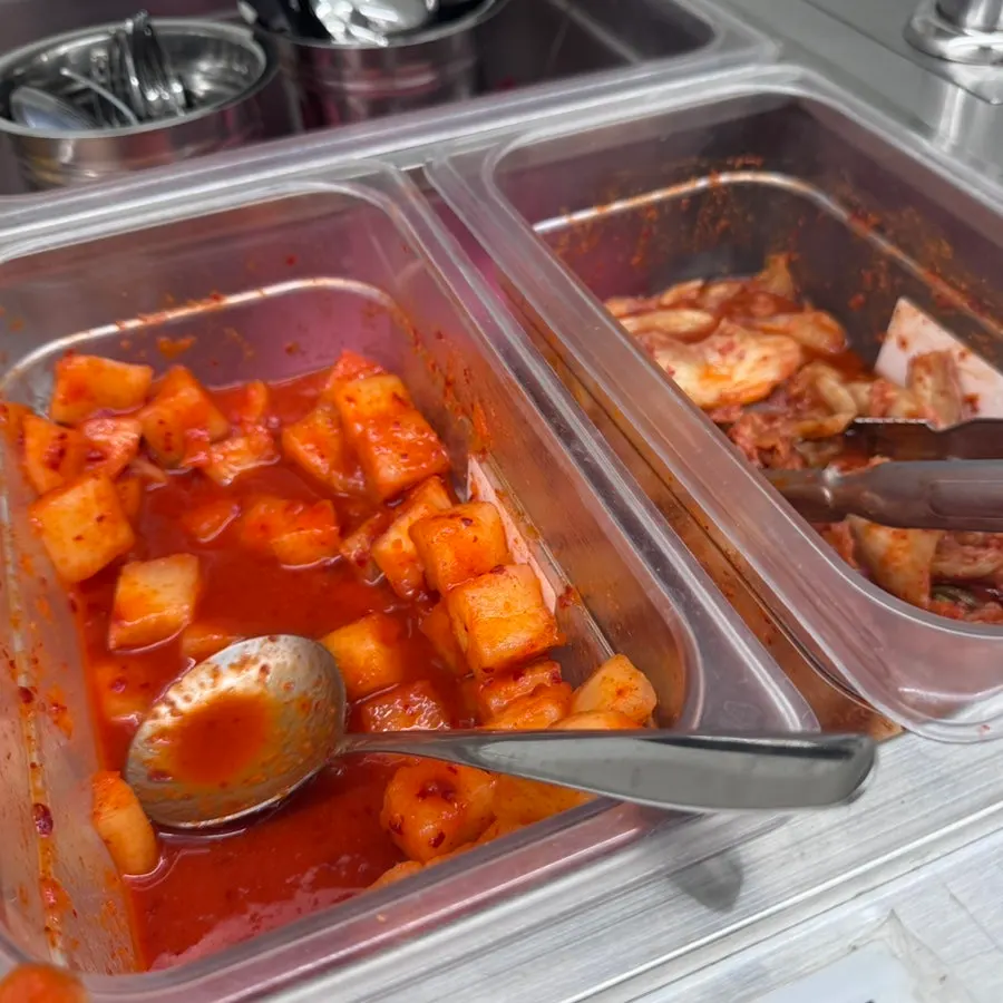 Pickled radish, diced radish kimchi, and spicy napa cabbage kimchi at the self-serve bar