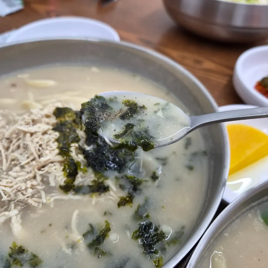 Chicken kalguksu topped with seaweed flakes