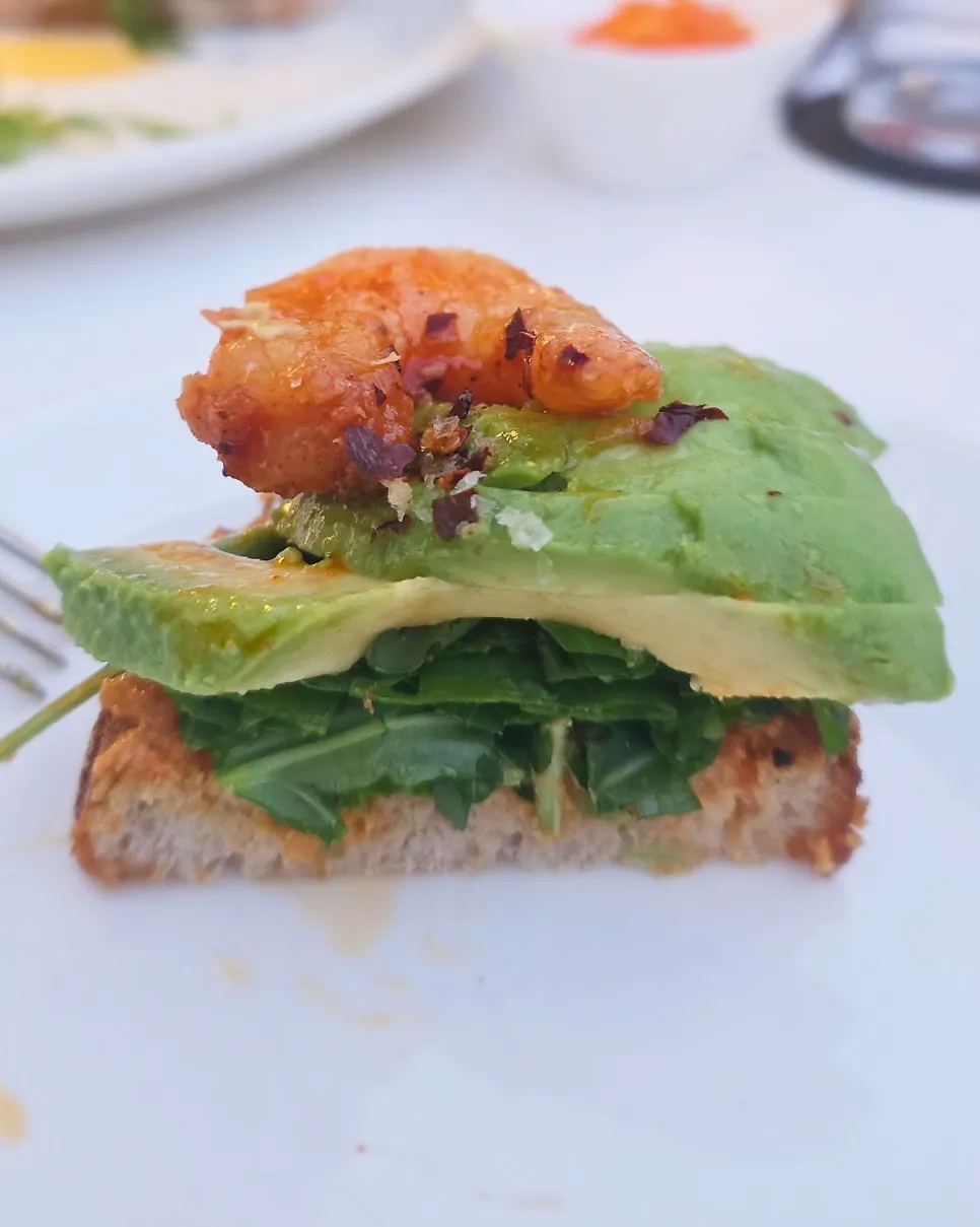 Open sandwich topped with grilled shrimp