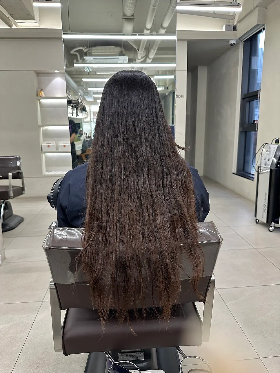 Before shot of waist-length hair before the service