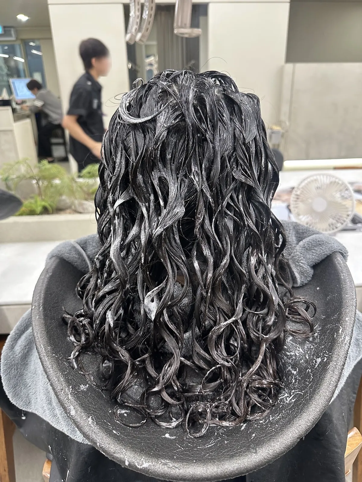 Front view of completed side bangs and hippie perm curls