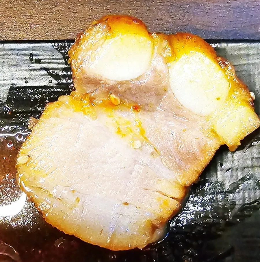 A piece of bossam wrapped in vegetables