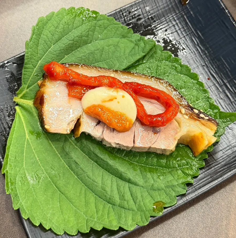 A piece of jokbal dipped in sauce