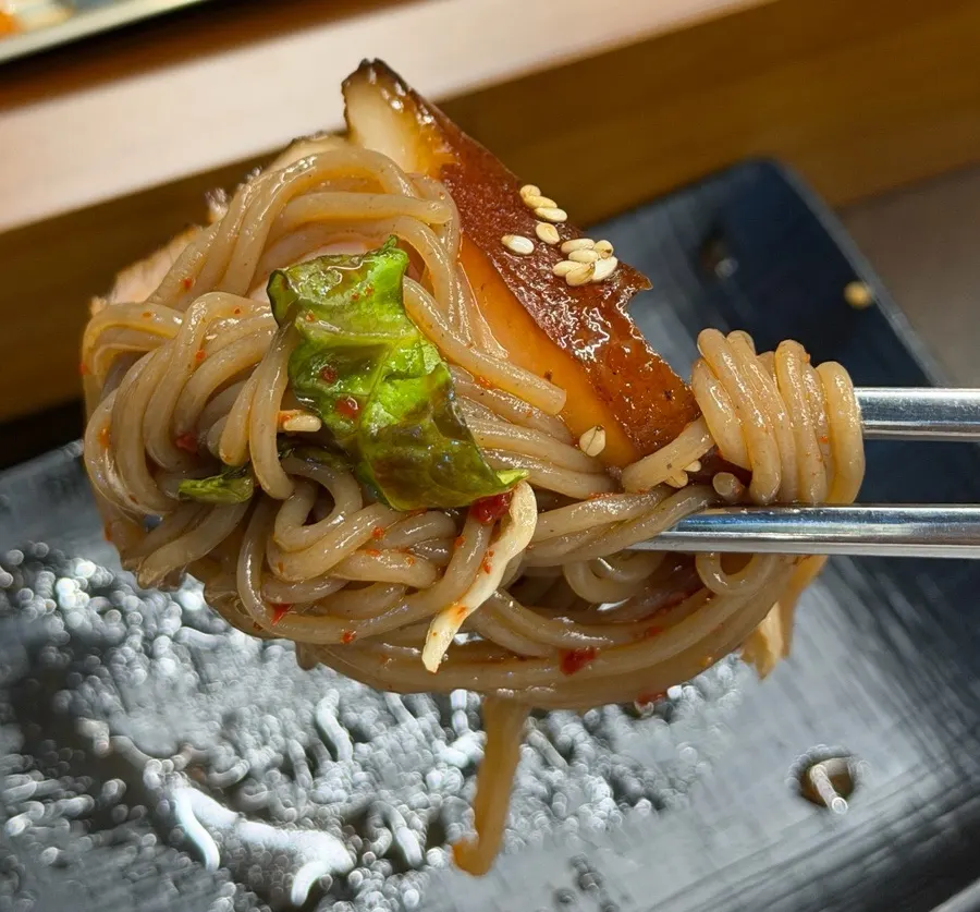 Free tangy makguksu noodles served as a side