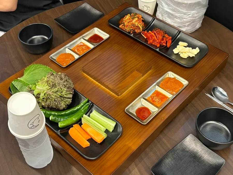 Basic table setting with lettuce wraps and three sauces