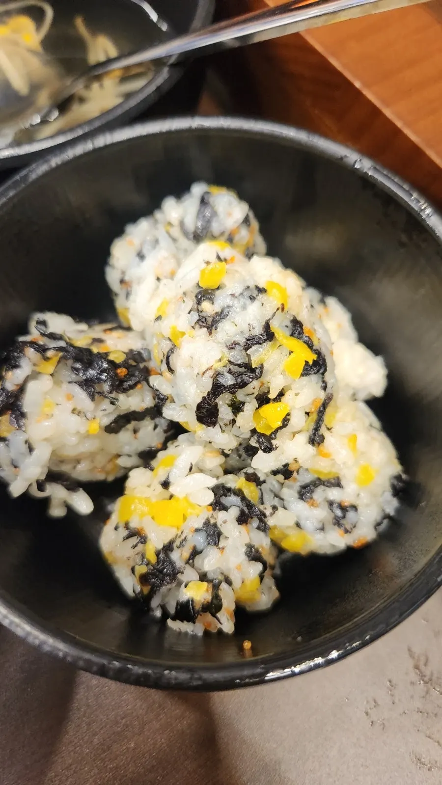 A hand-formed rice ball with sesame oil
