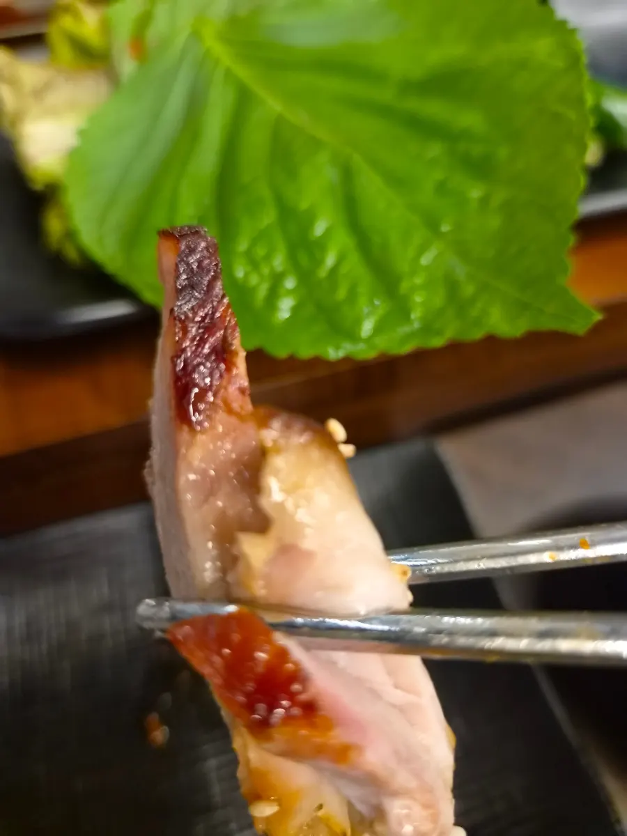 Jokbal dipped in salted shrimp and spicy-sweet sauce