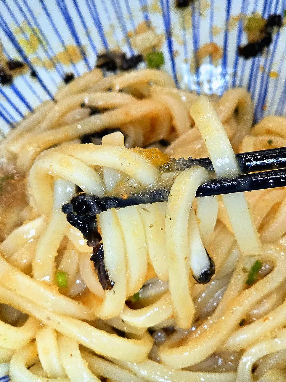 Mentaiko Bibim Udon mixed with the egg yolk popped in