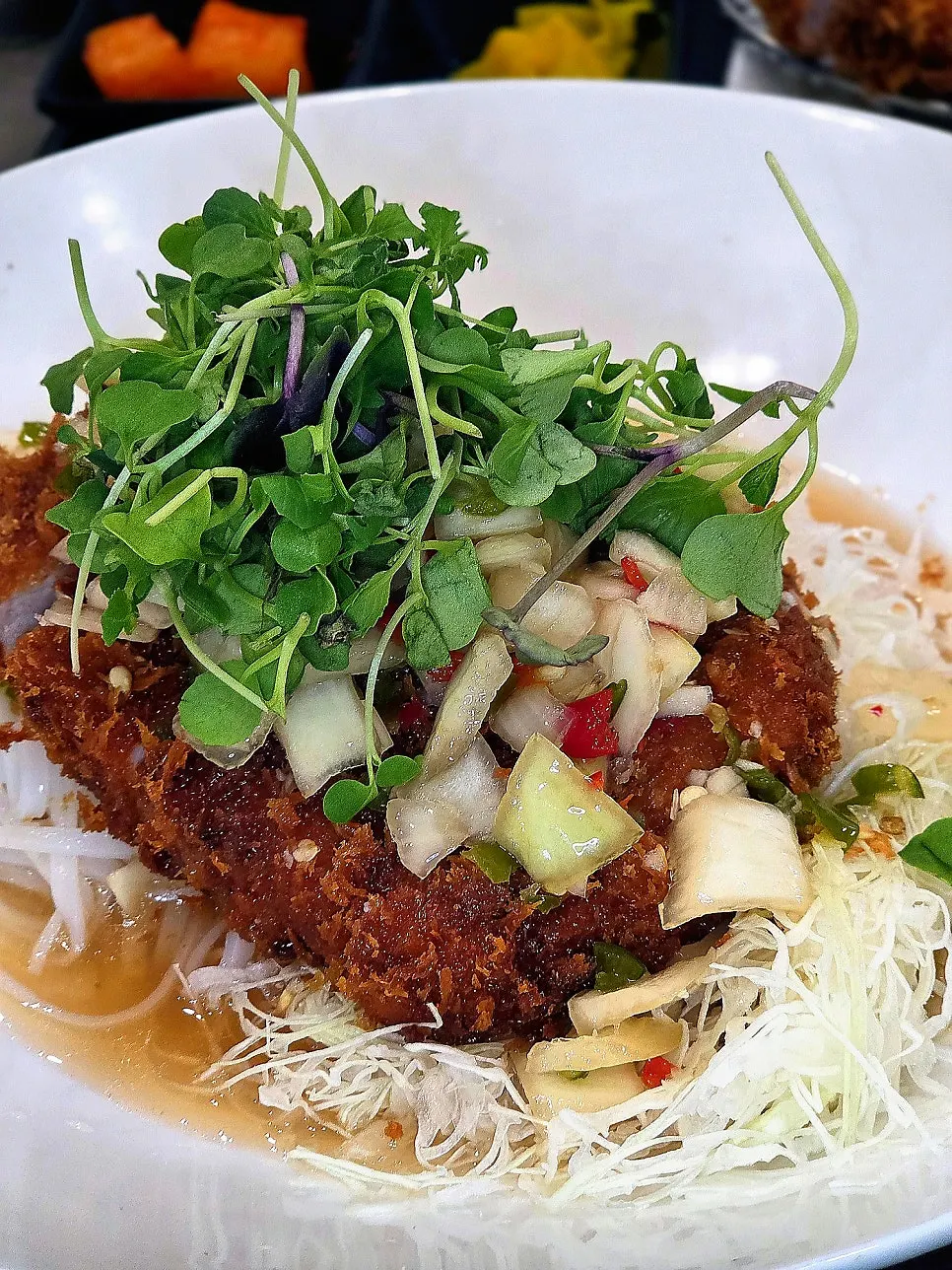 Aqua Pork Cutlet with rice noodles and vegetables underneath