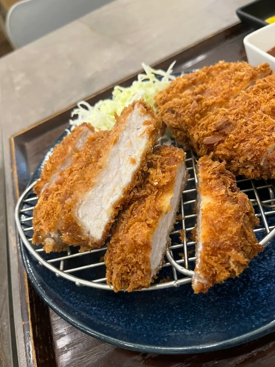 Picking up a piece of pork cutlet