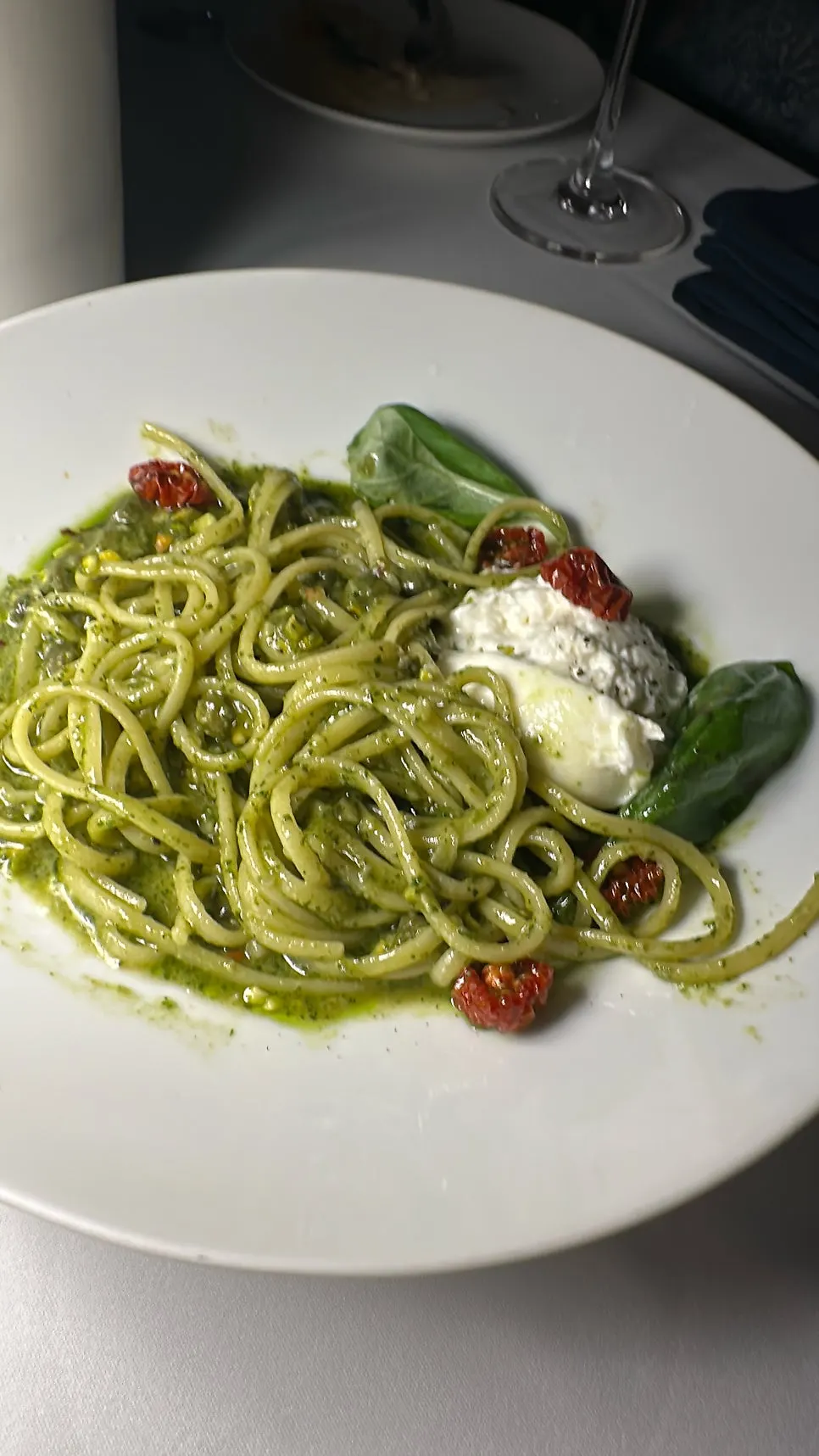 Basil pesto pasta topped with pistachios