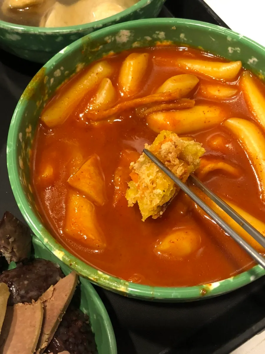 Fried snacks dipped in tteokbokki sauce