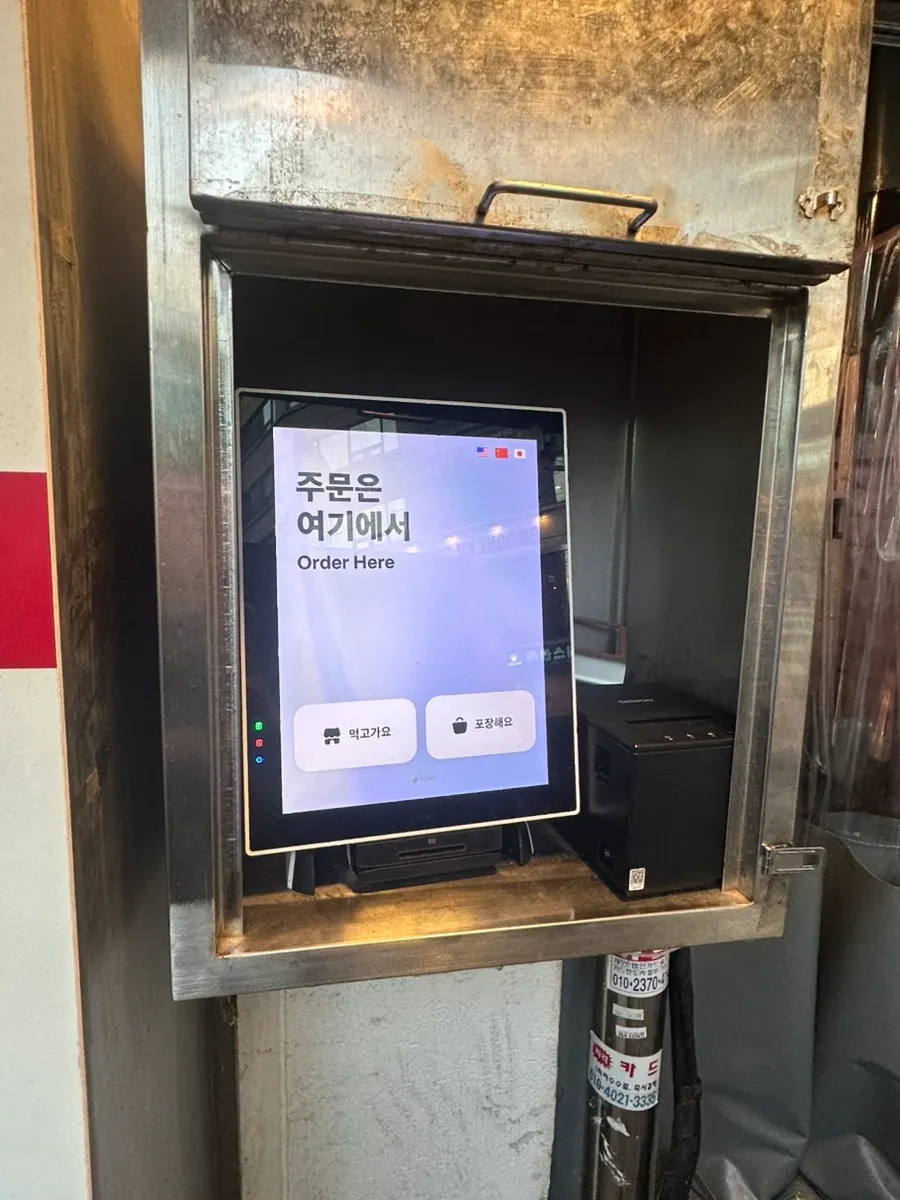 Korean snack-bar menu information outside the restaurant