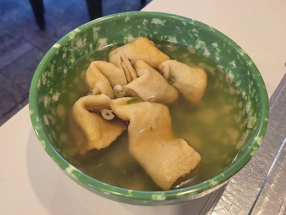 Twisted skewer fish cake served in broth