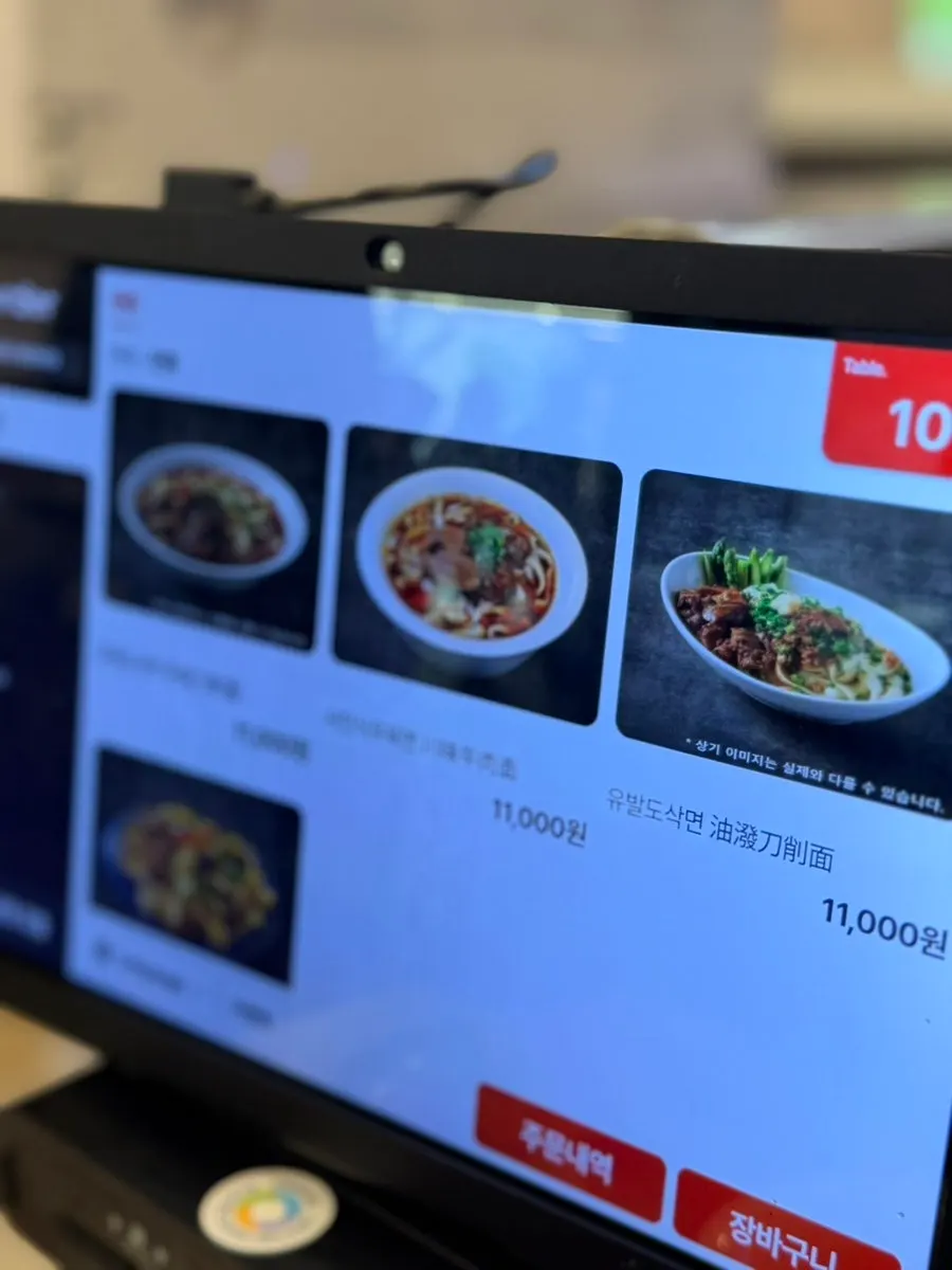Menu board listing dim sum and solo-meal dishes
