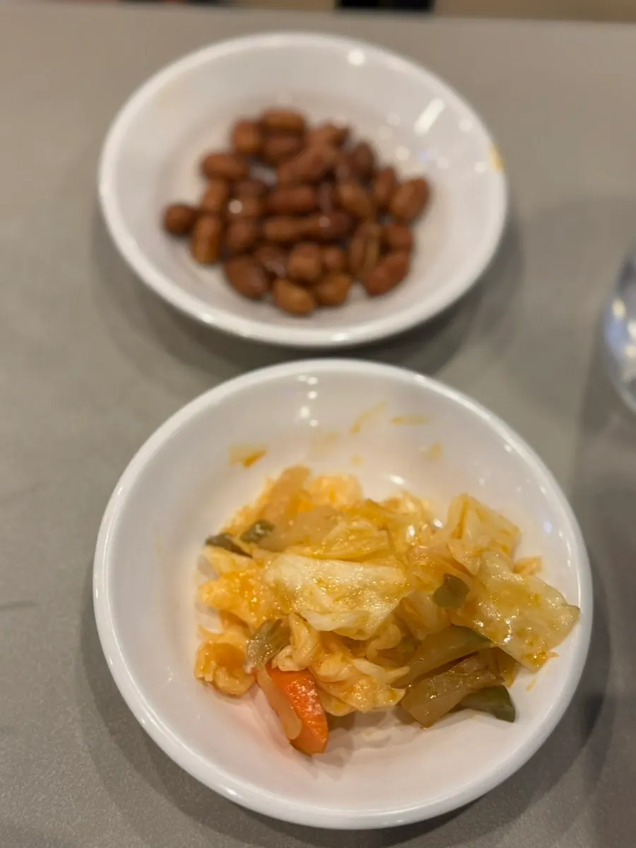 Complimentary peanuts and pickled cabbage side dishes
