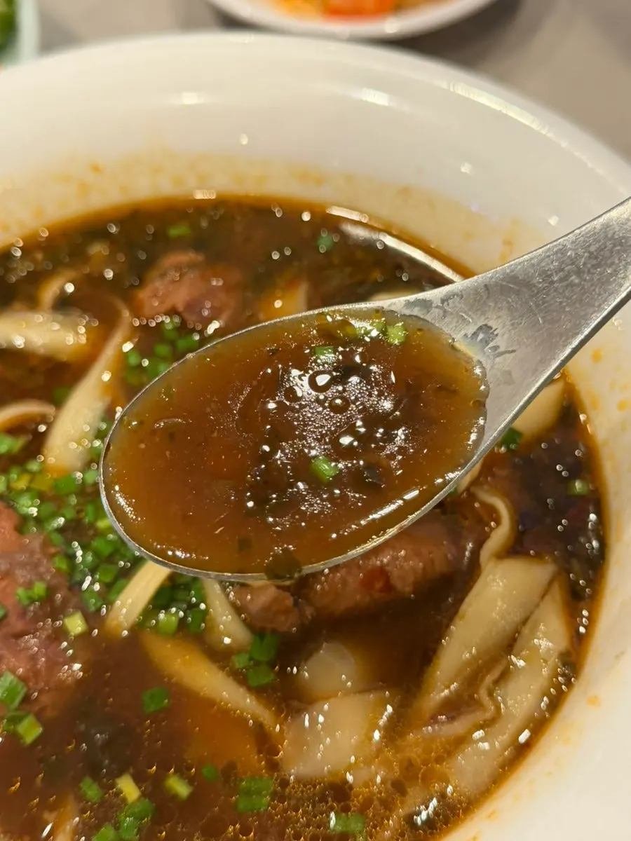 Close-up of beef in the knife-cut noodle dish