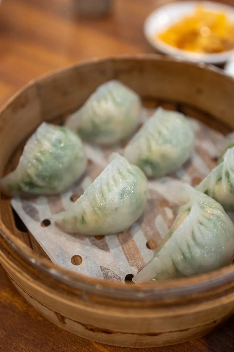 Table setting with both crystal moon dumplings and xiaolongbao