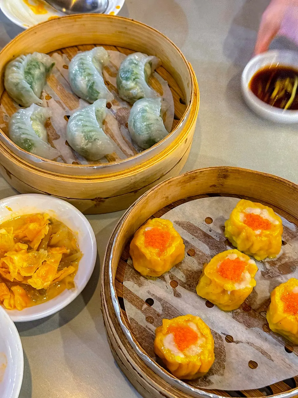 Crystal dumplings and shumai served in a steamer basket