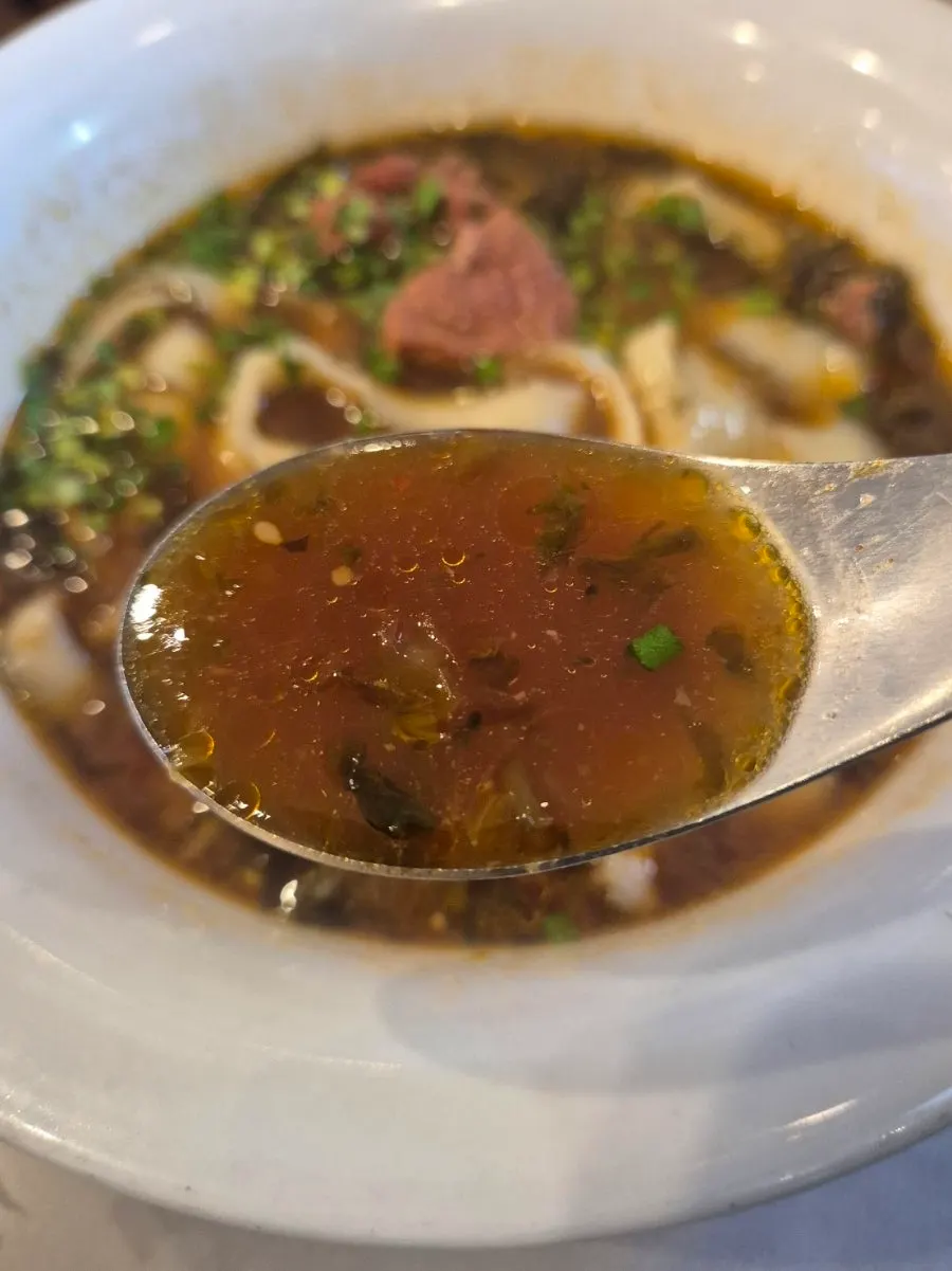 Thick slices of beef on top of beef knife-cut noodles