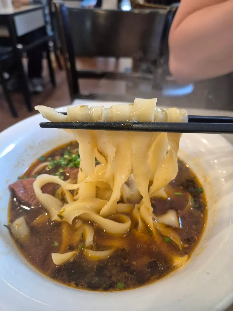 Beef knife-cut noodle broth with mustard leaf salad