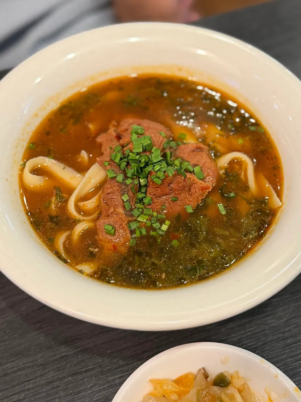 A bowl of beef dosakmyeon with rich broth