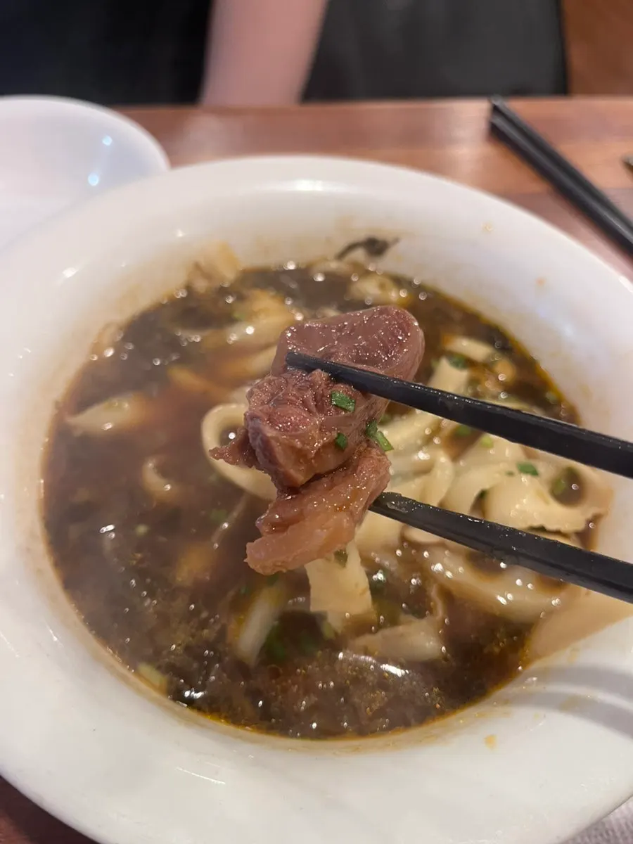 Full spread of uyuk dosakmyeon, shumai, and yuxiang pork rice bowl