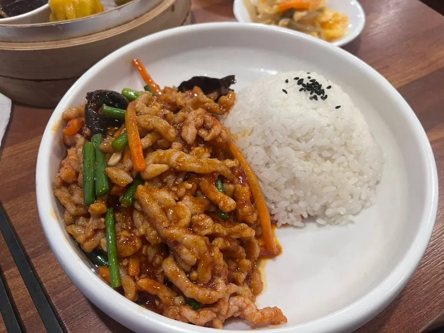 Yuxiang pork rice bowl topped with sauce