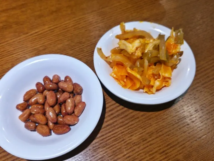 Complimentary peanuts and jjachai side dishes