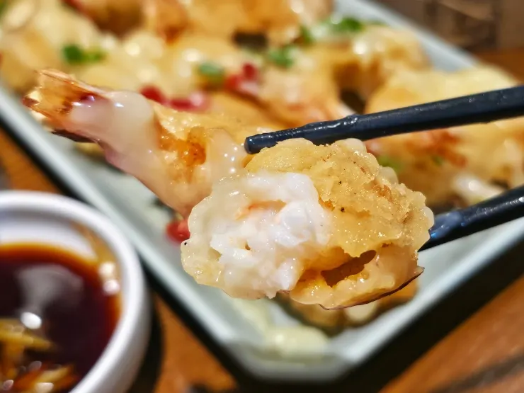 Cream shrimp cut in half showing the shrimp meat inside