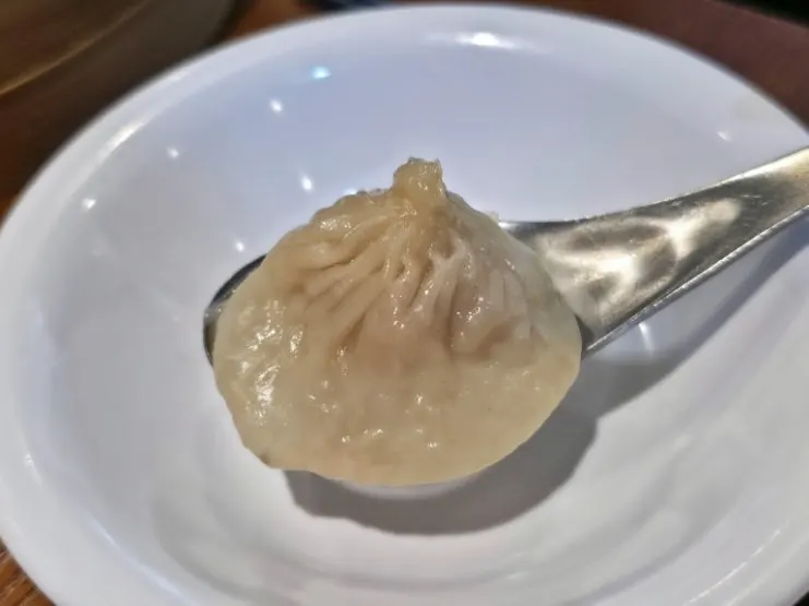 Eating xiaolongbao topped with ginger