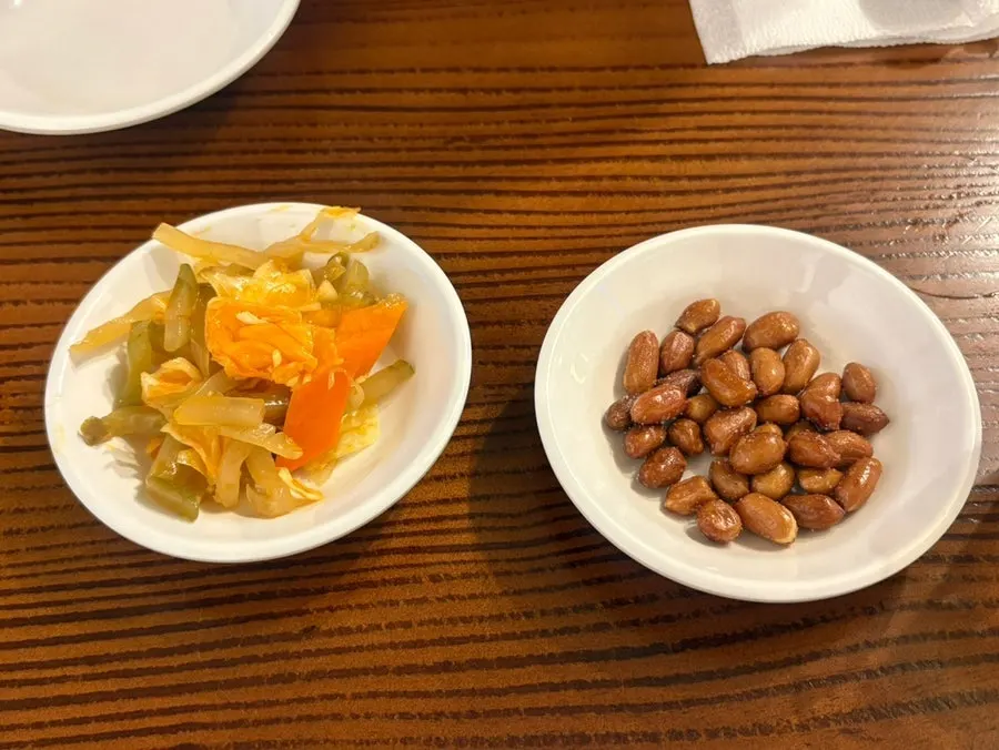 Complimentary peanuts and pickled side dishes