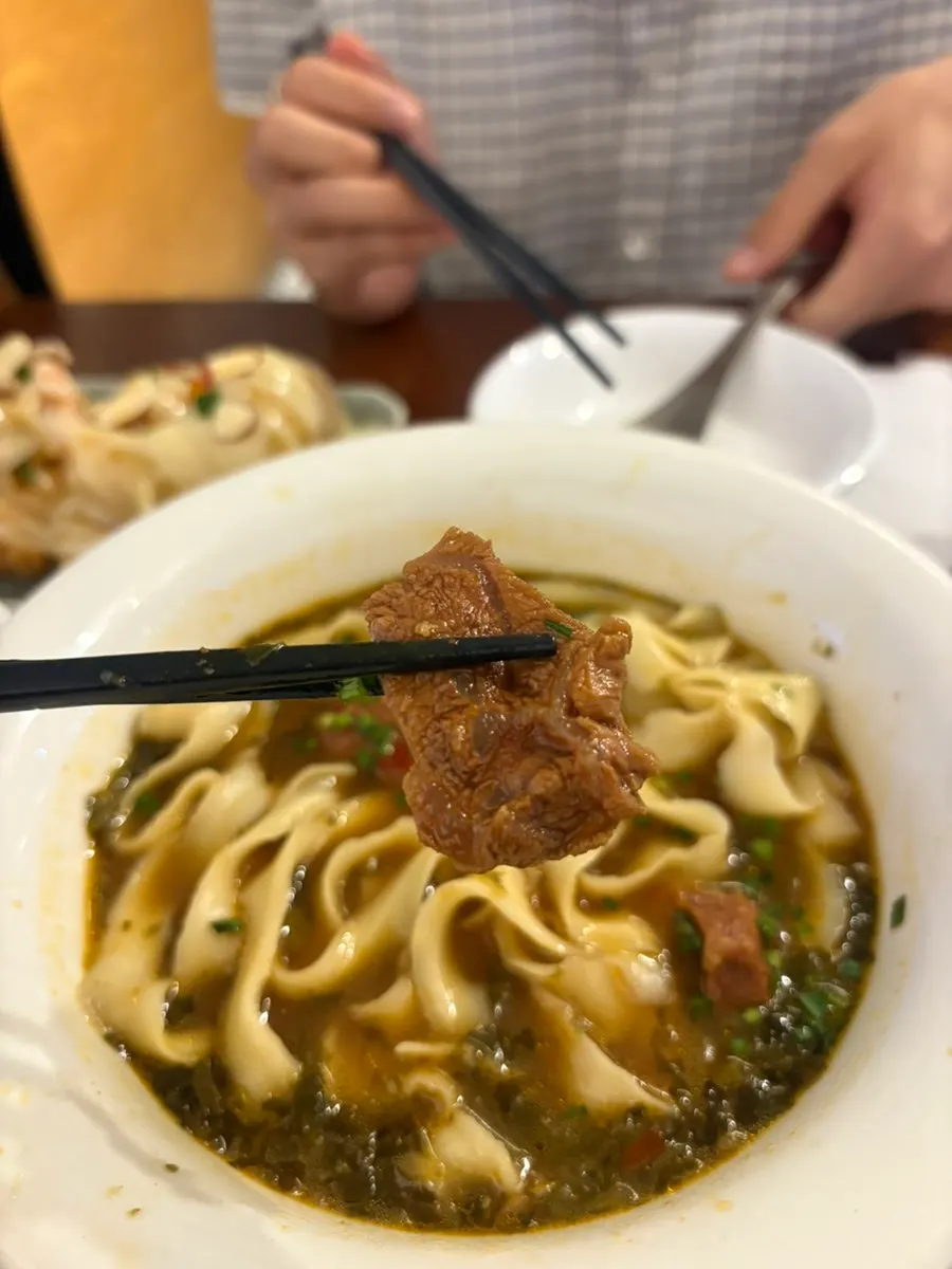 Tender beef pieces inside the beef noodle soup