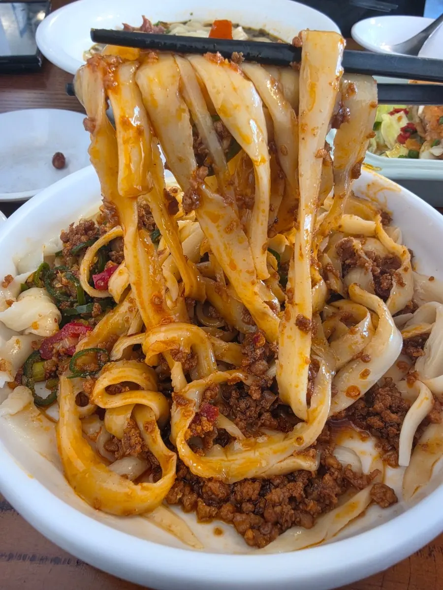Knife-cut noodles and fried dishes shared at Cheonghwawon