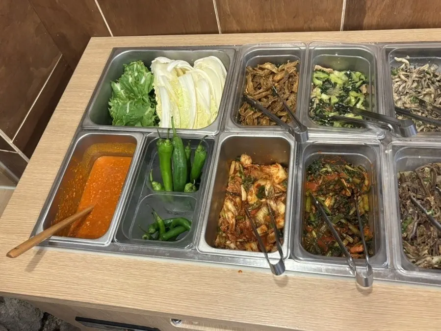 Self-serve bar with salad and extra side dishes