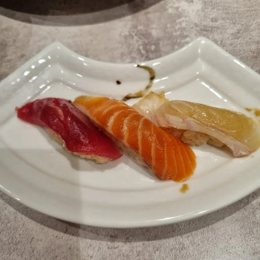 Sushi plate topped with soy sauce and wasabi