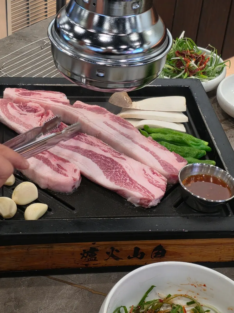 A full table of aged meat at Baeksan Hwarro