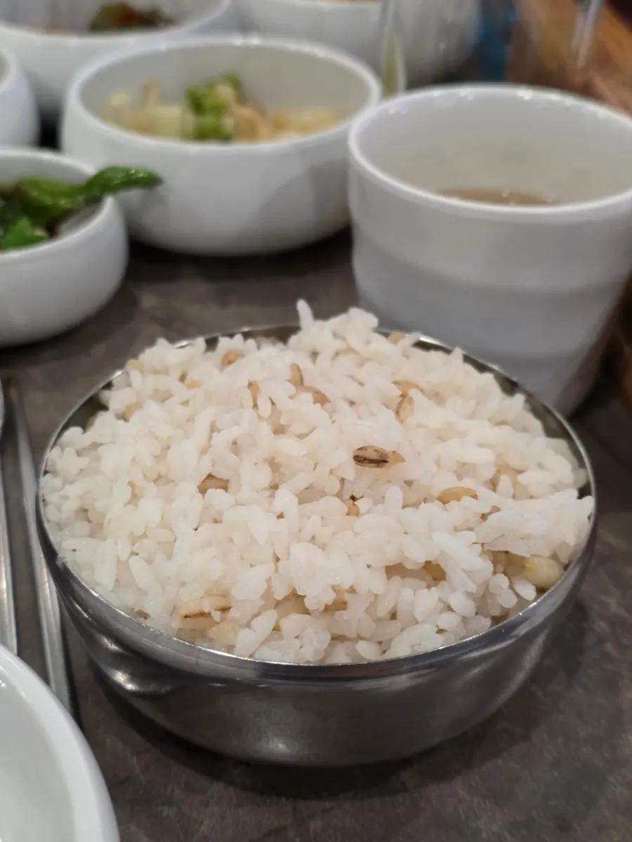 Kimchi cheonggukjang in an earthenware pot and a bowl of rice