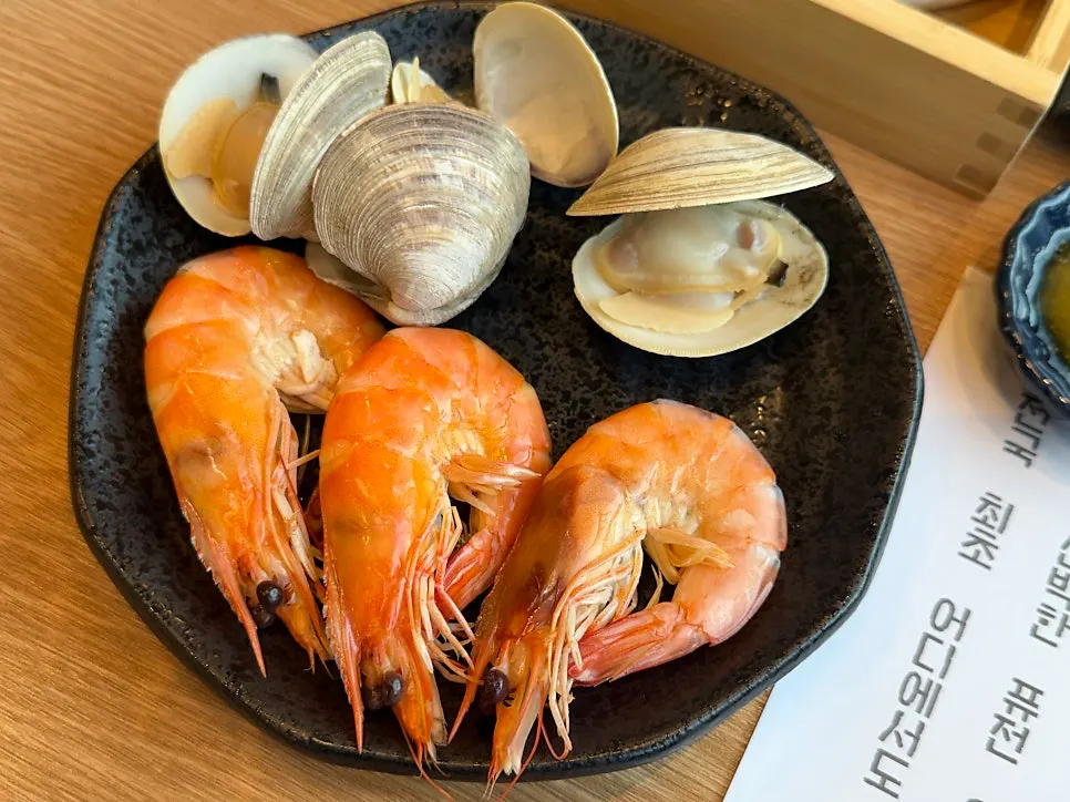Seasonal steamed dongjuk clams and king prawns