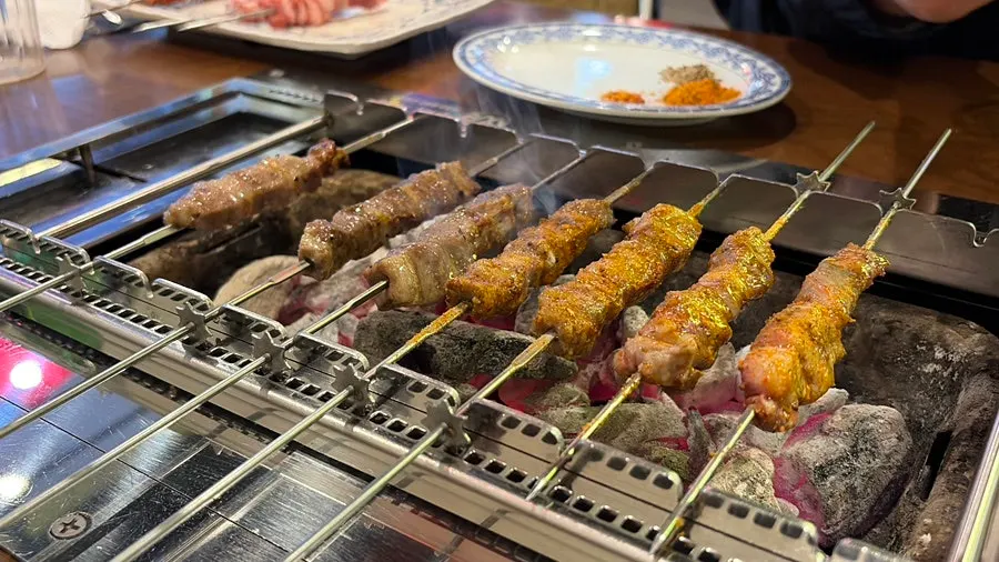 Ten lamb skewers grilling
