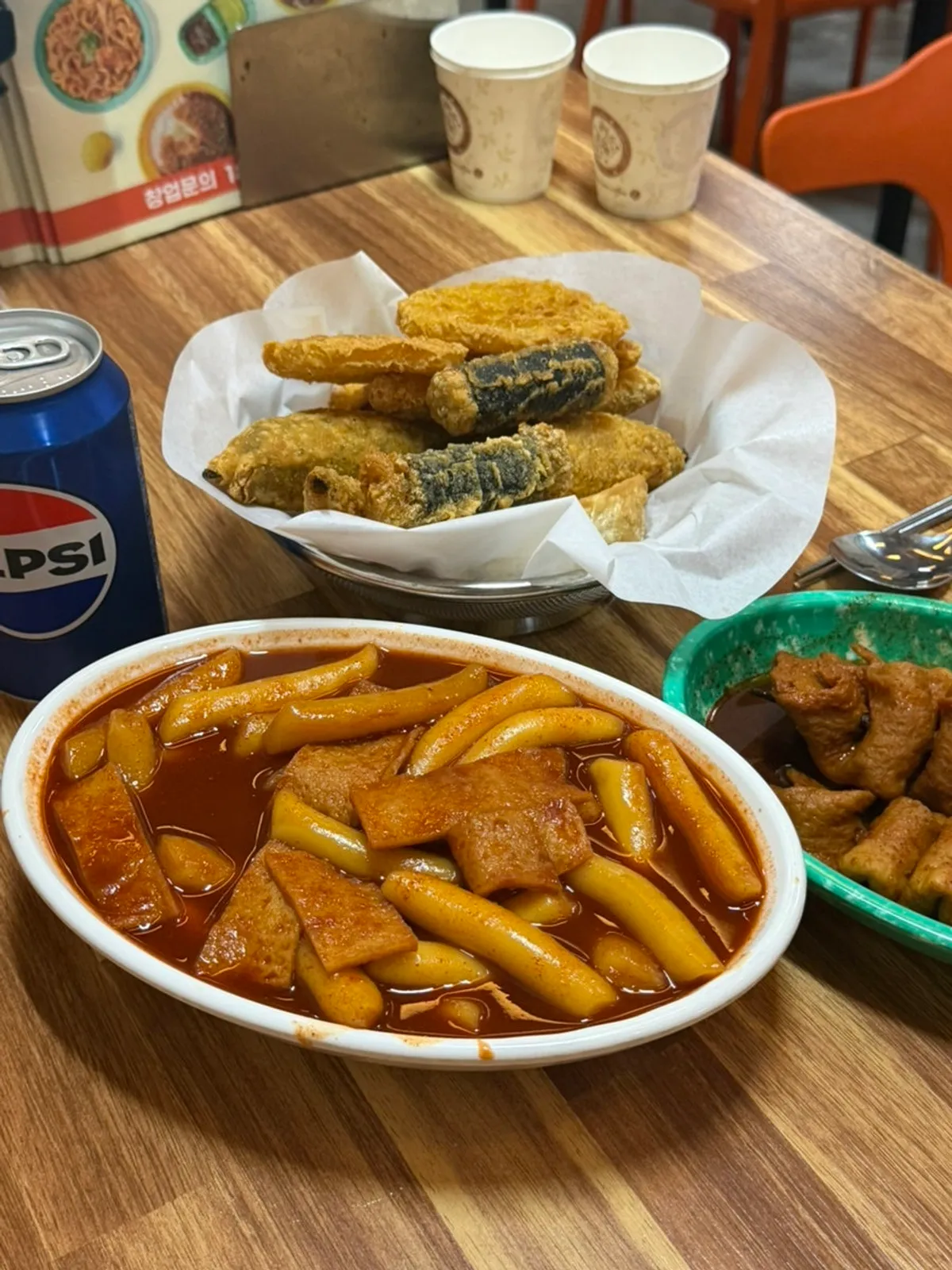 Table spread of duri tteokbokki, spicy odeng and fried snacks