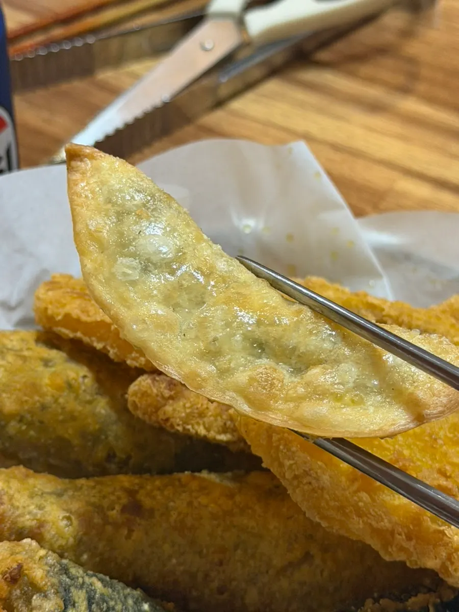 A plate of golden-colored fried snacks