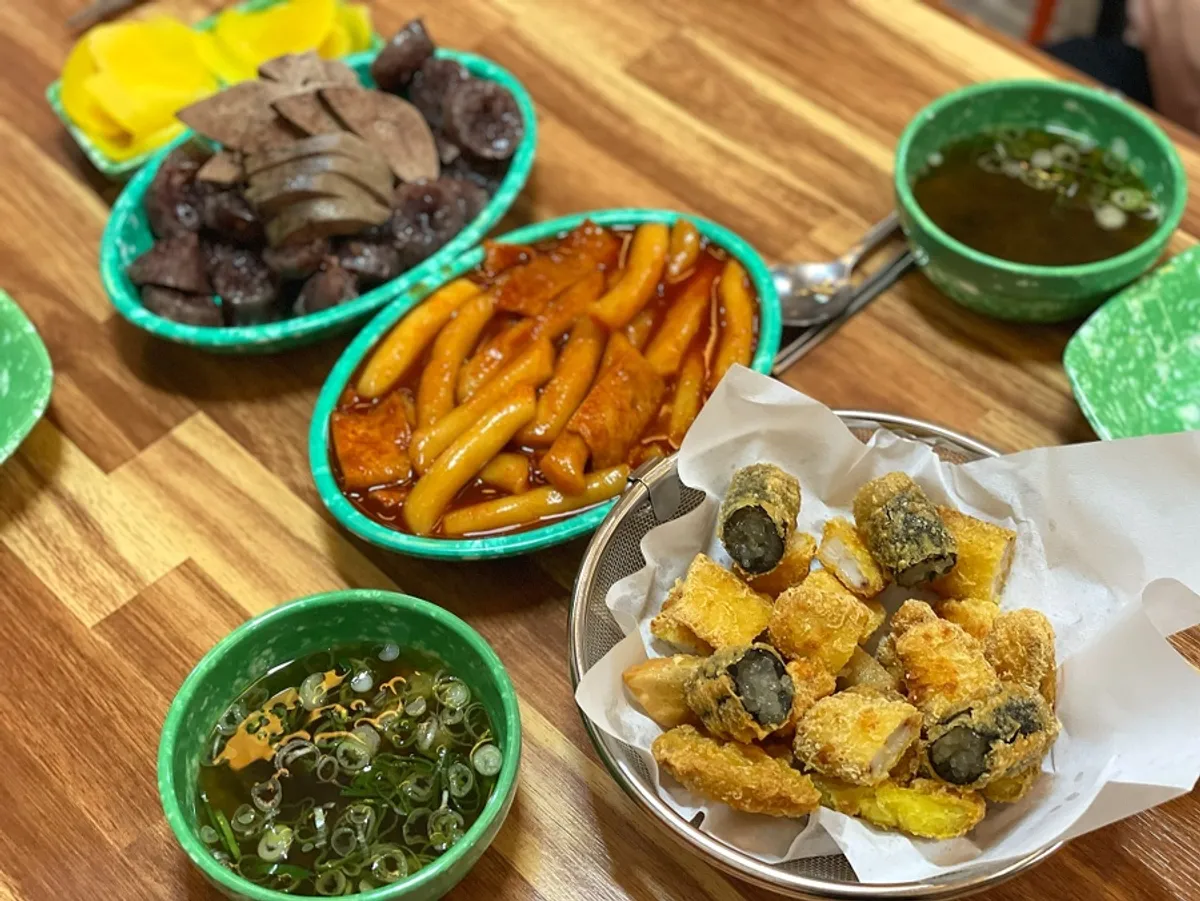 A full spread of tteokbokki, sundae, and fried snacks